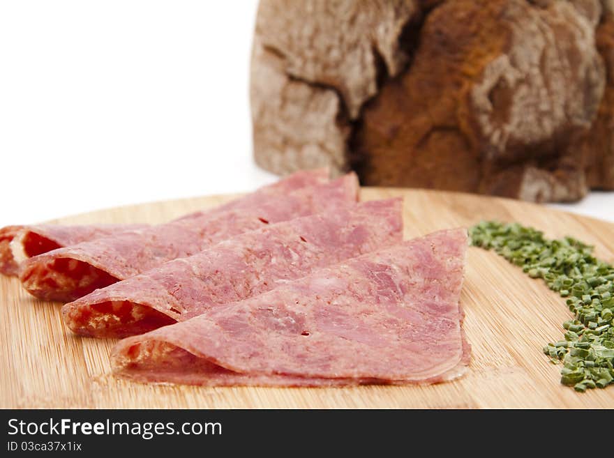 Corned beef with chives and bread onto wood plates. Corned beef with chives and bread onto wood plates