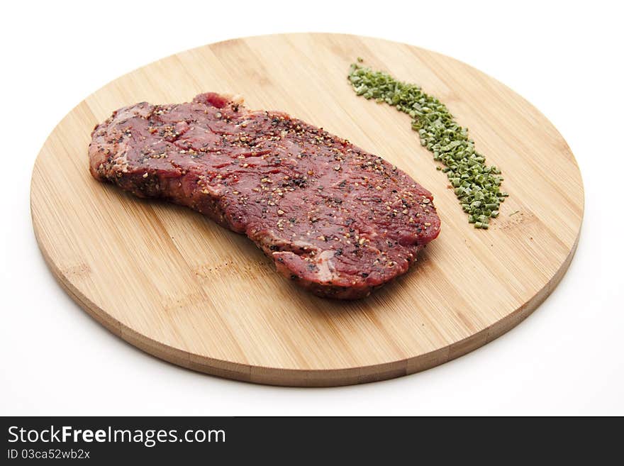 Steak seasoned with chives onto wood plates