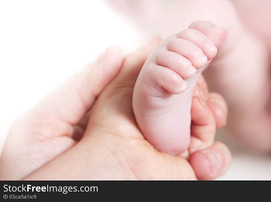 Child and mothers hand holding babys foot