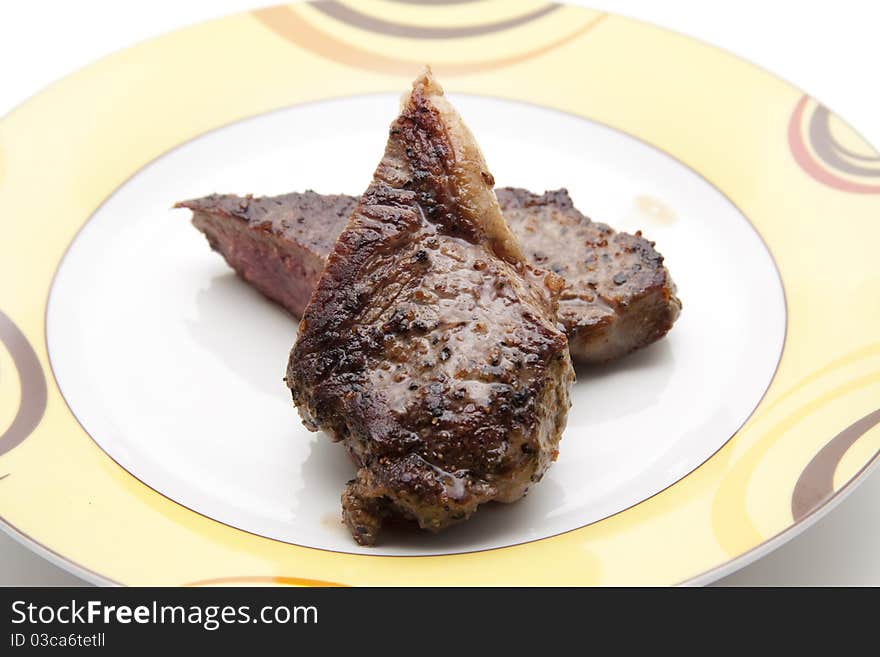 Seasoned steak and on ceramics plate