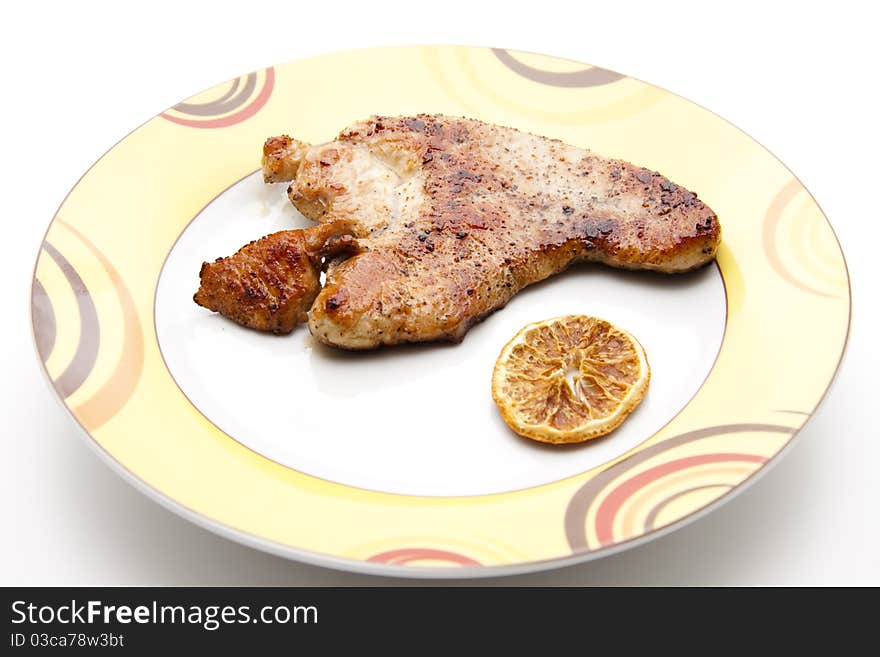 Turkey hen steak roasted with lemon onto plates