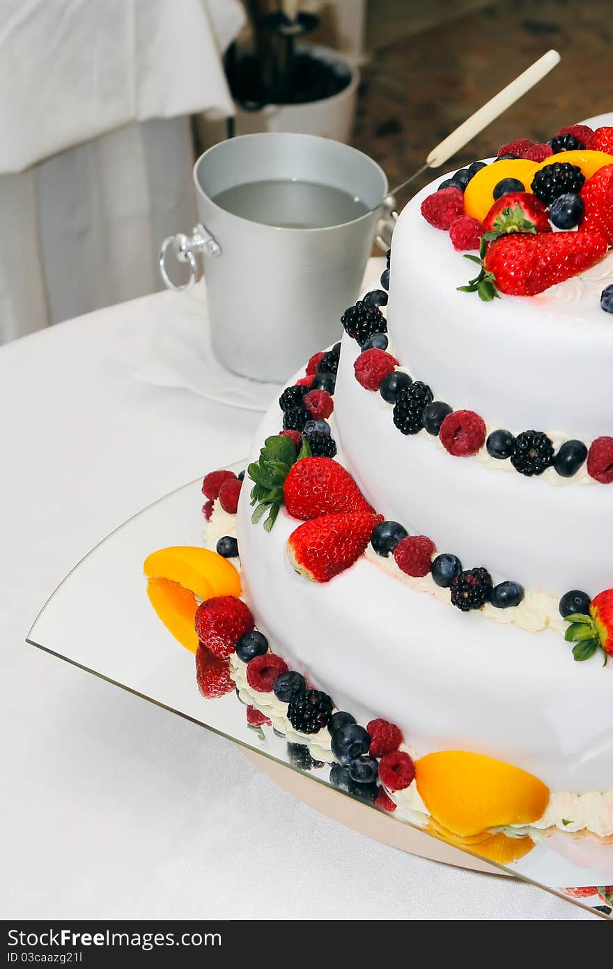 Fresh wedding fruitcake with strawberries, raspberries, blackberries, peaches and blueberries