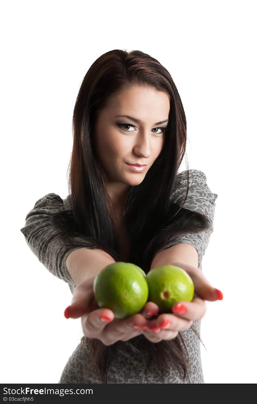 Young woman holding and giving away limes isolated on white