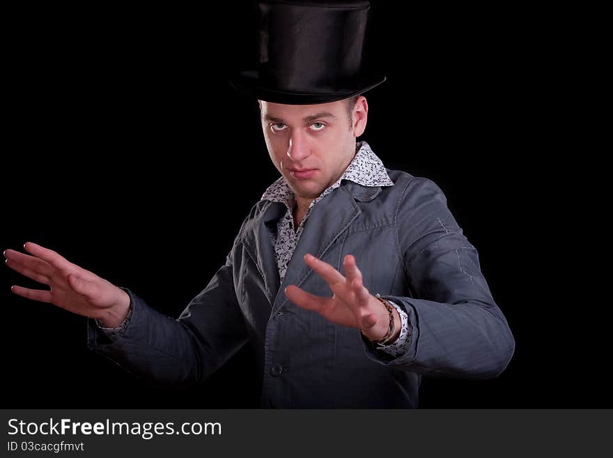 Emotional portrait of the young man in a black top-hat. Emotional portrait of the young man in a black top-hat