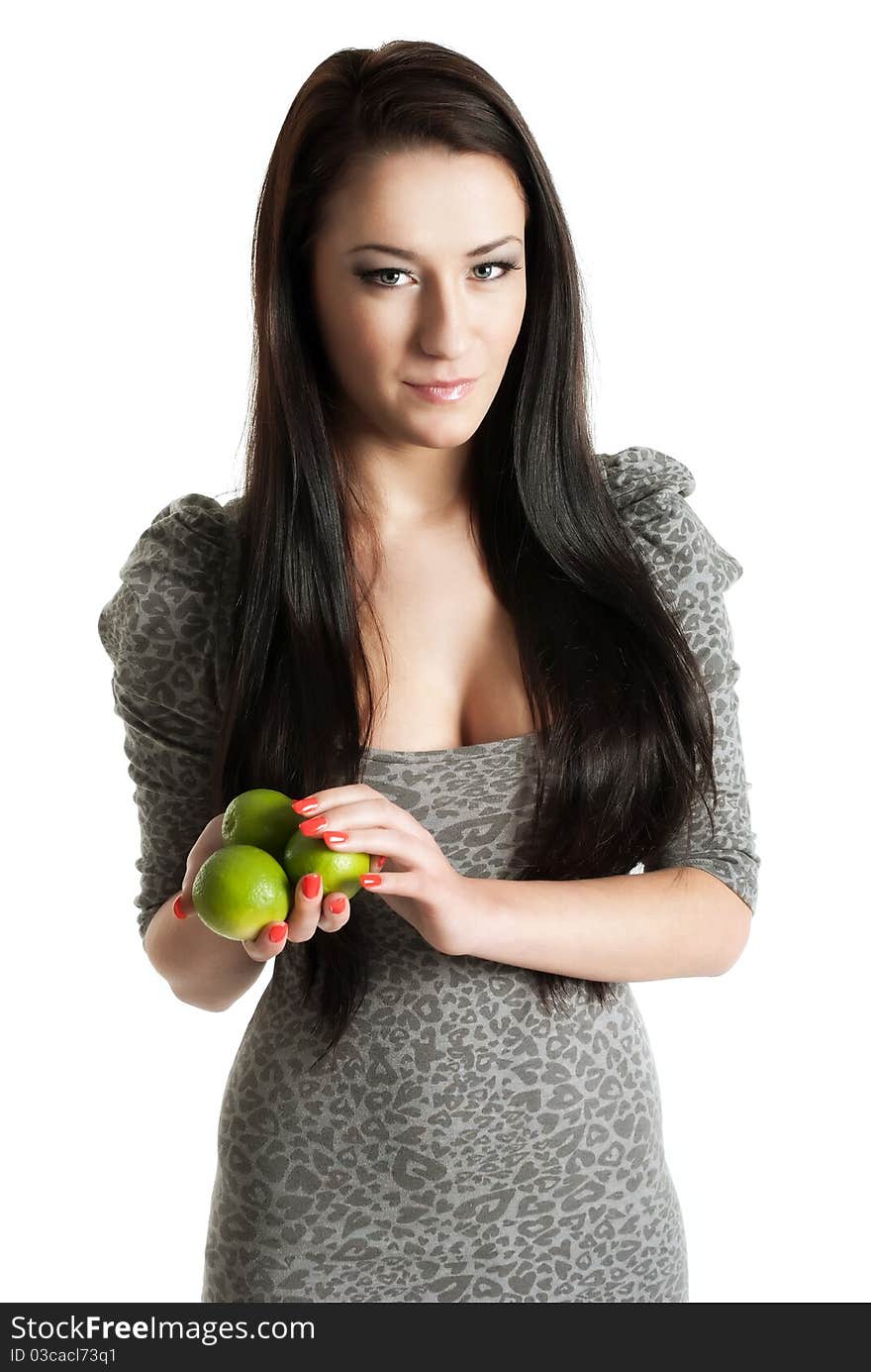 Young woman holding limes isolated on white