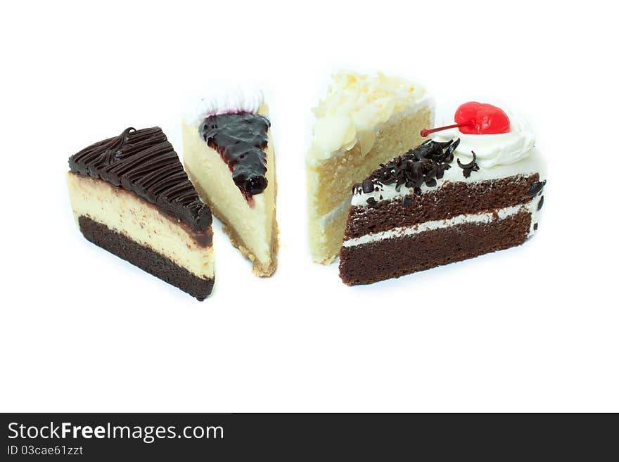 Four different pieces of cake. Isolated on white background.