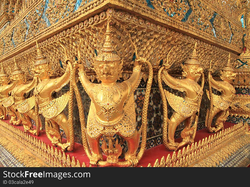 Gold ornamental patter statuettes in Grand palace, Bangkok, Thailand.