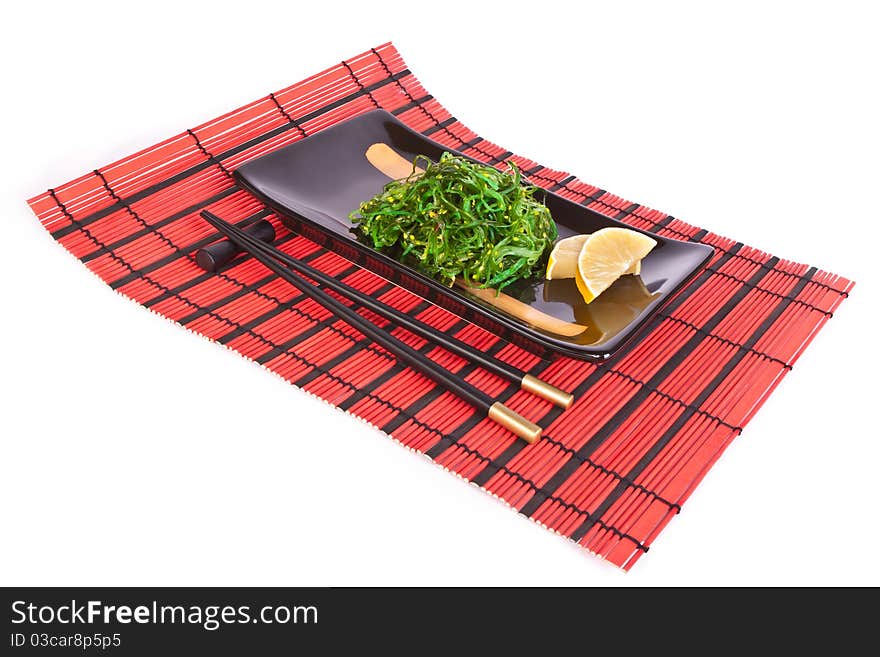 Plate with chuka salad on a red mat