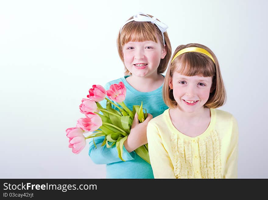 Little Girls Holding Bouquet Of Tulips