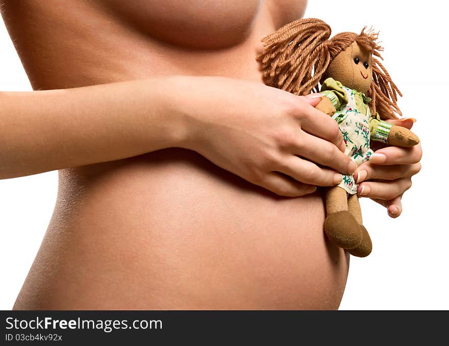 Pregnant woman holding a doll. Pregnant woman holding a doll