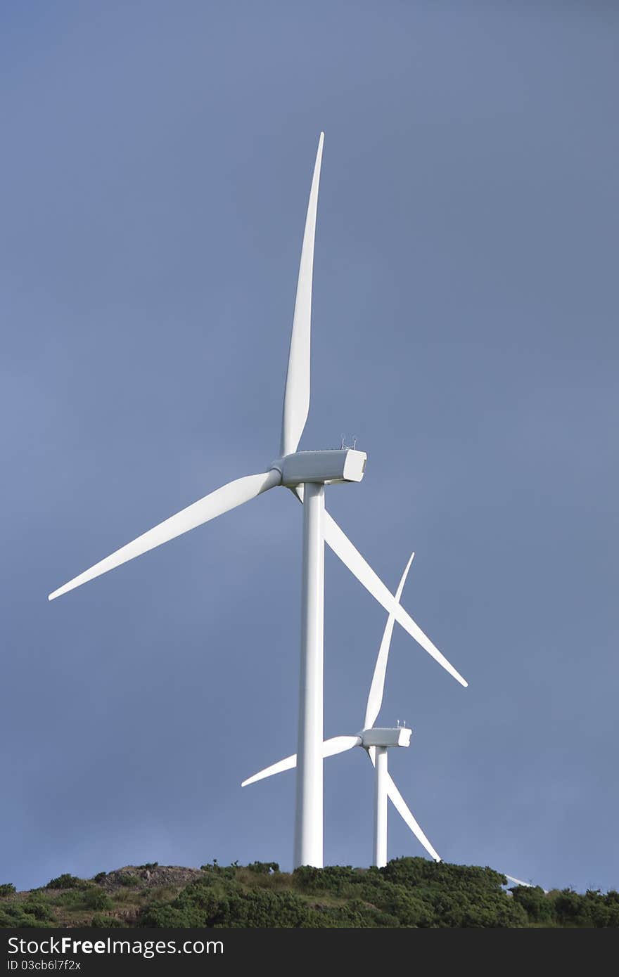 A pair of wind turbines generateing energy