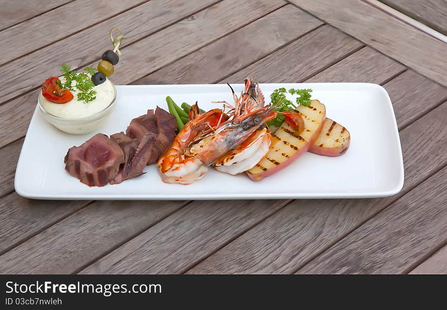 Seafood and meat in one plate