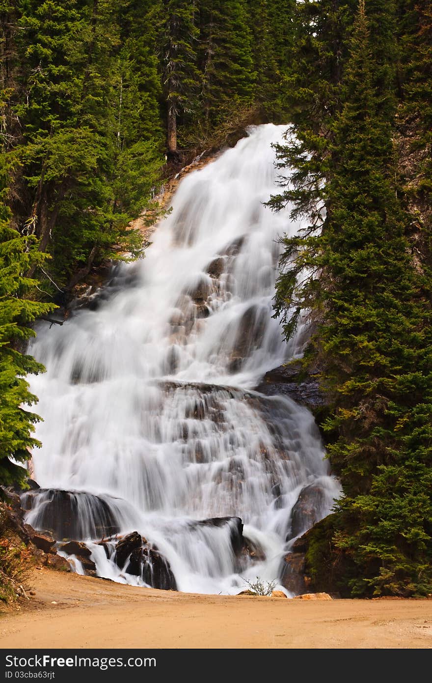 Mountain waterfall cascades down steep rocks, Montana. Mountain waterfall cascades down steep rocks, Montana.