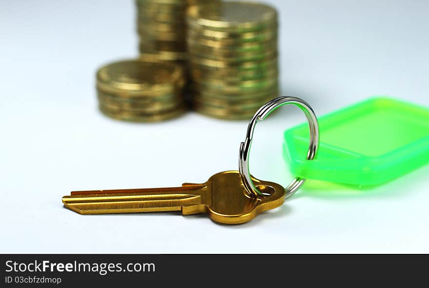 A Golden key placed in front of three piles of gold coins asking the question how good are your financial foundations. A Golden key placed in front of three piles of gold coins asking the question how good are your financial foundations.