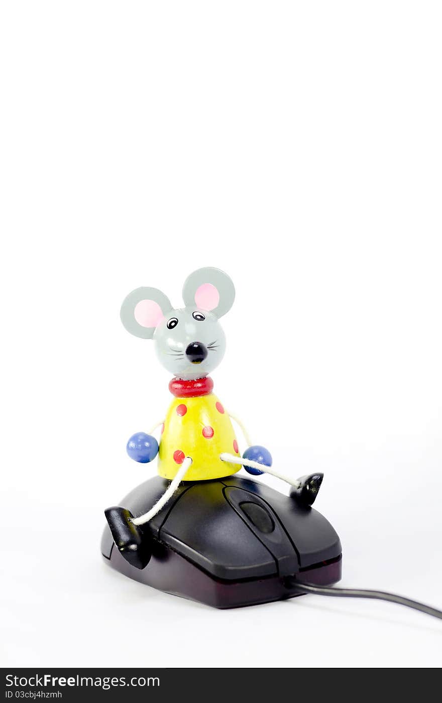 A toy mouse on a computer mouse. A toy mouse on a computer mouse