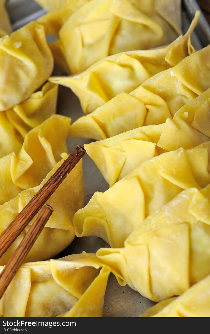 Chinese dumplings wrapped in dumpling skin ready to be cooked. Chinese dumplings wrapped in dumpling skin ready to be cooked.