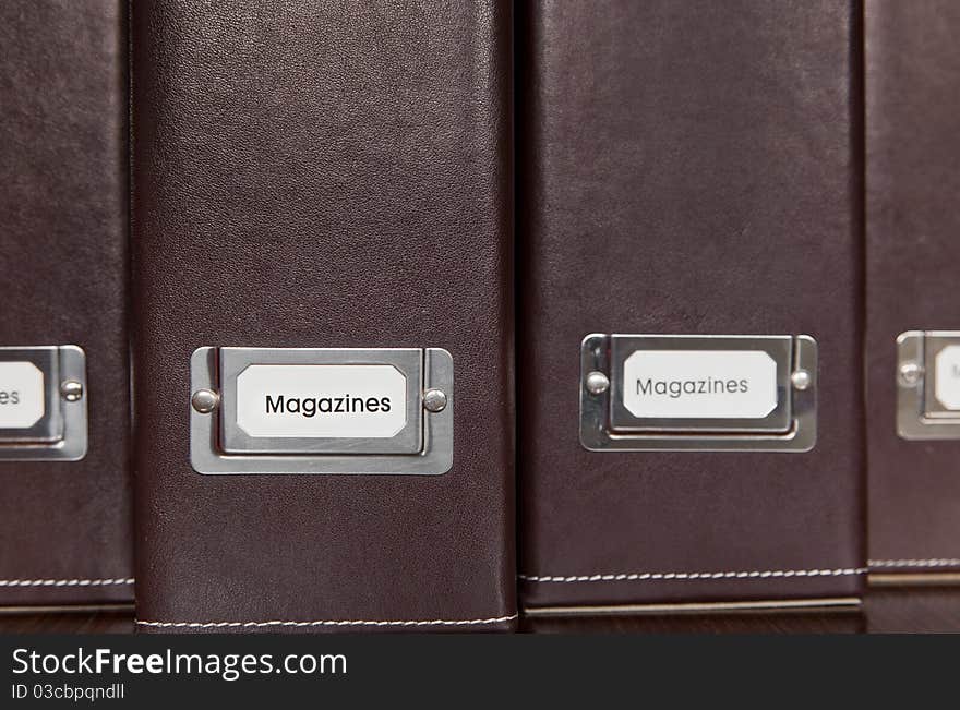 Brown leather magazine holders in a row.