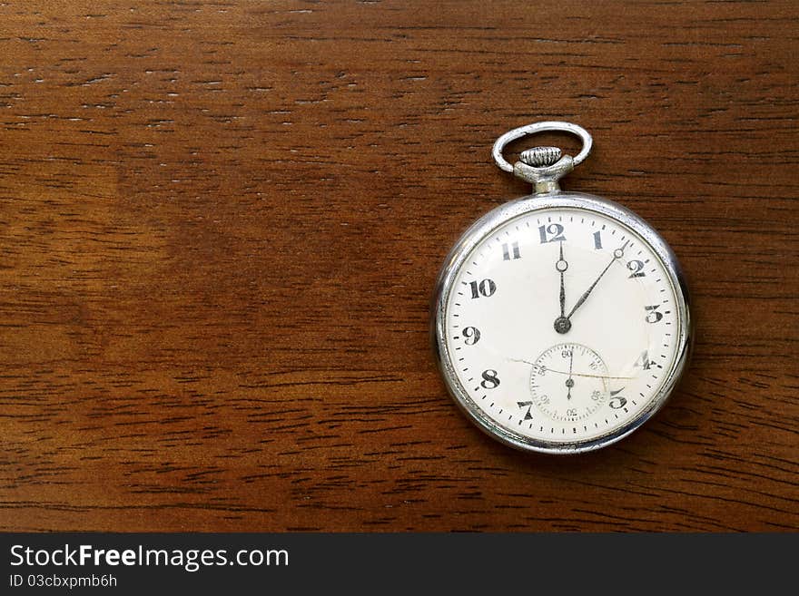 Pocket watch on wood board