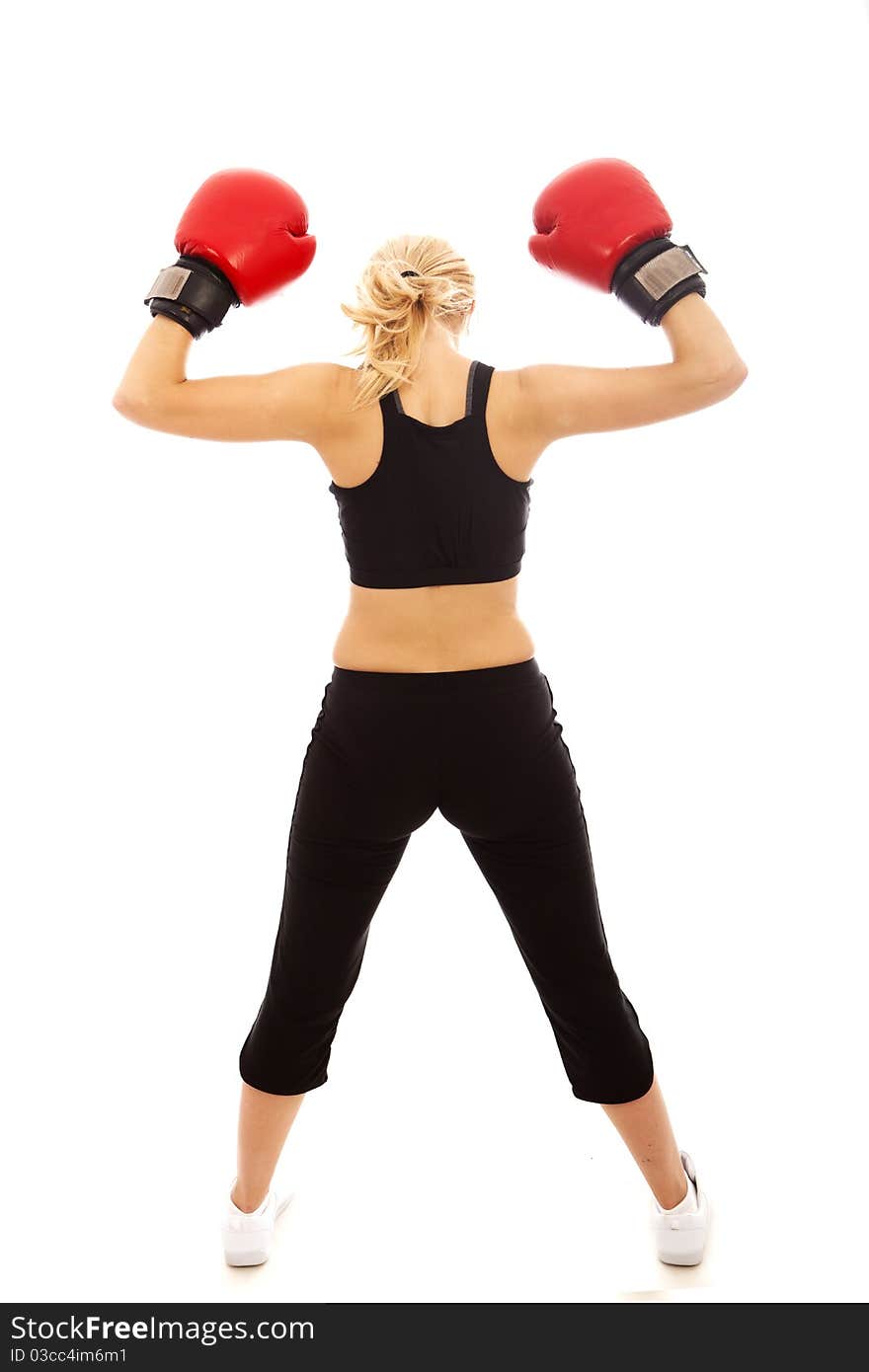 A female wearing red boxing gloves holding her arms in the air. A female wearing red boxing gloves holding her arms in the air