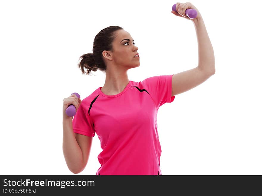 A young female lifting exercise weghts on a white background. A young female lifting exercise weghts on a white background