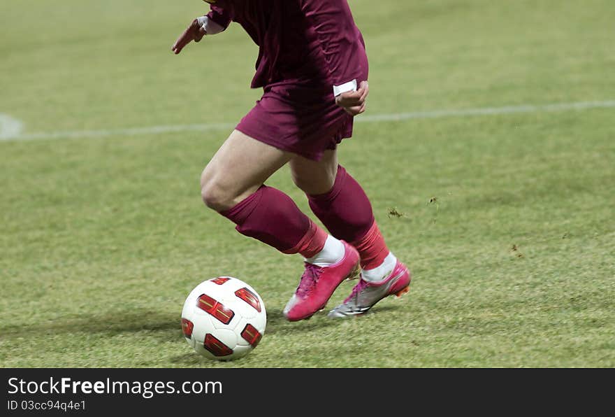 Soccer players running after the ball