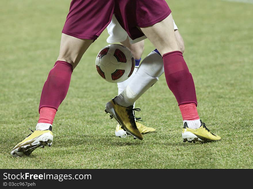 Soccer players running after the ball