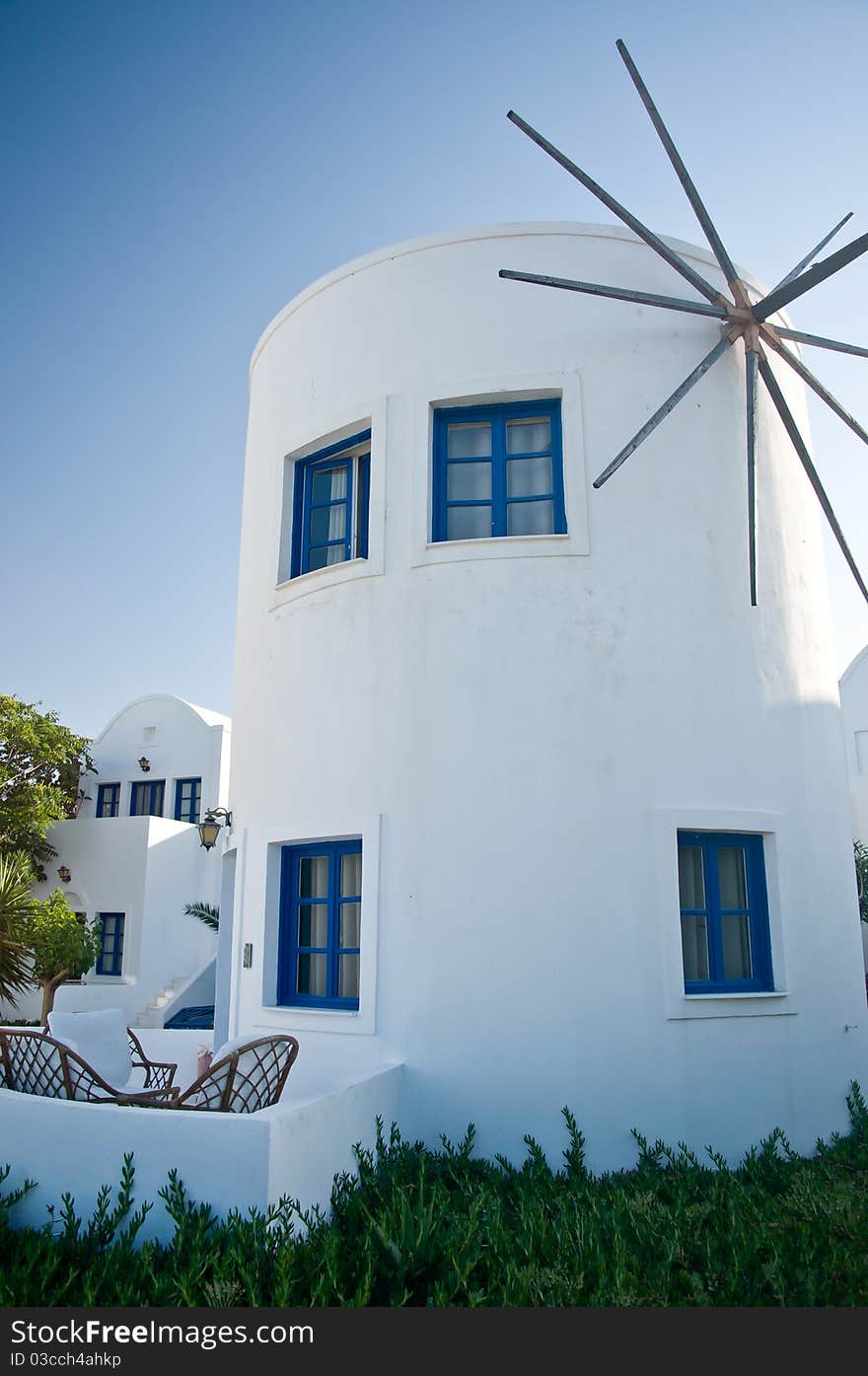 White Windmill with blue Windows in GreeceWhite. White Windmill with blue Windows in GreeceWhite