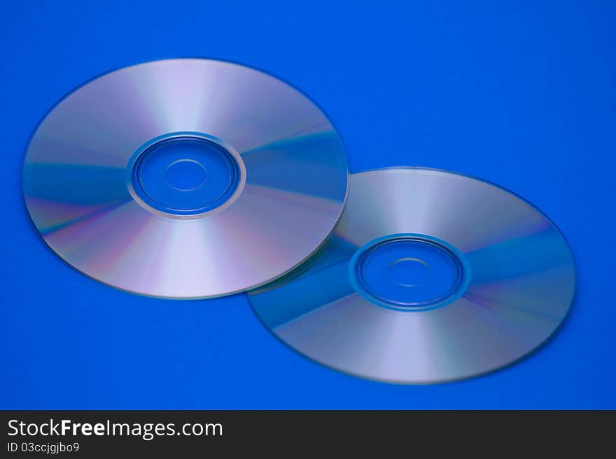 Tvo CDs on blue backrgound.