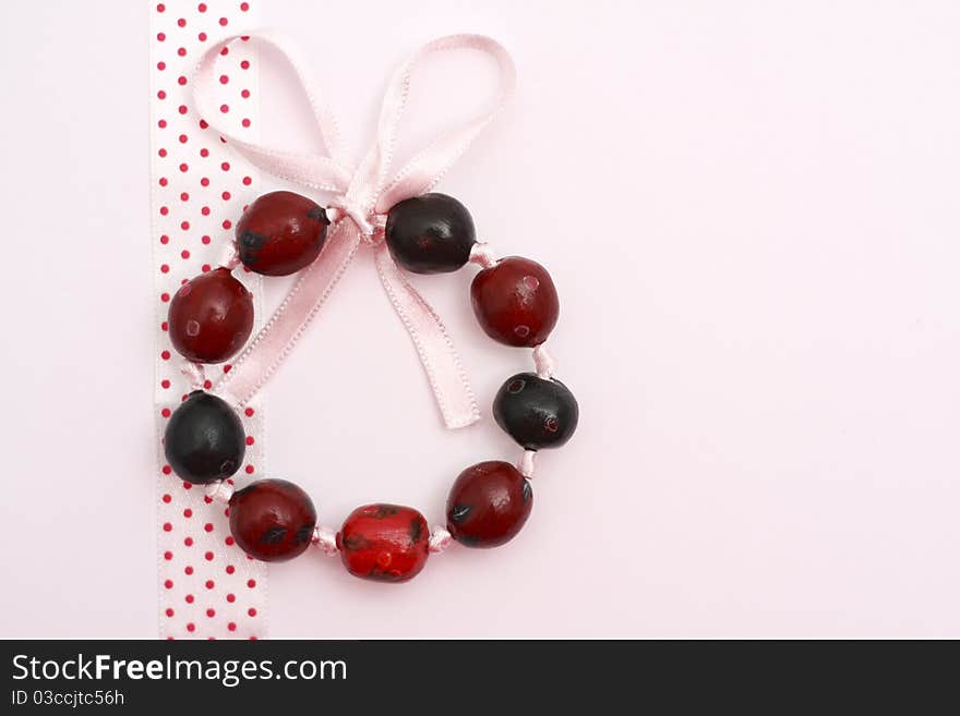 Hand painted beads bracelet on fabric and white background. Hand painted beads bracelet on fabric and white background