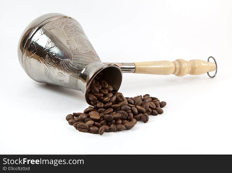 Coffee maker with coffee beans on white background