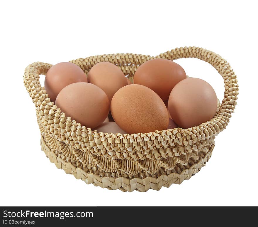 Easter eggs in brown basket on a white background