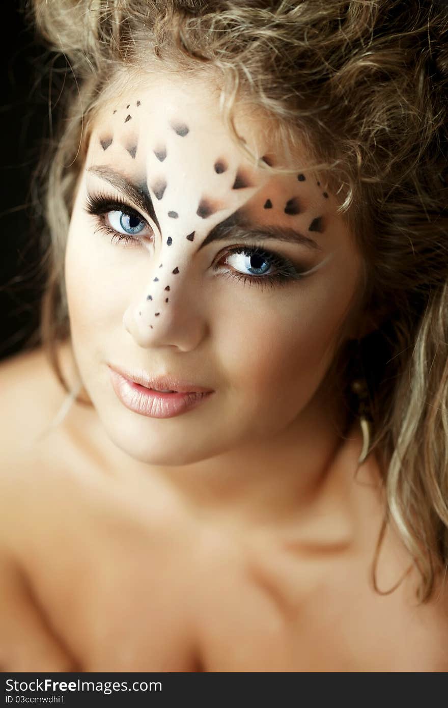 Girl with an unusual make-up as a leopard