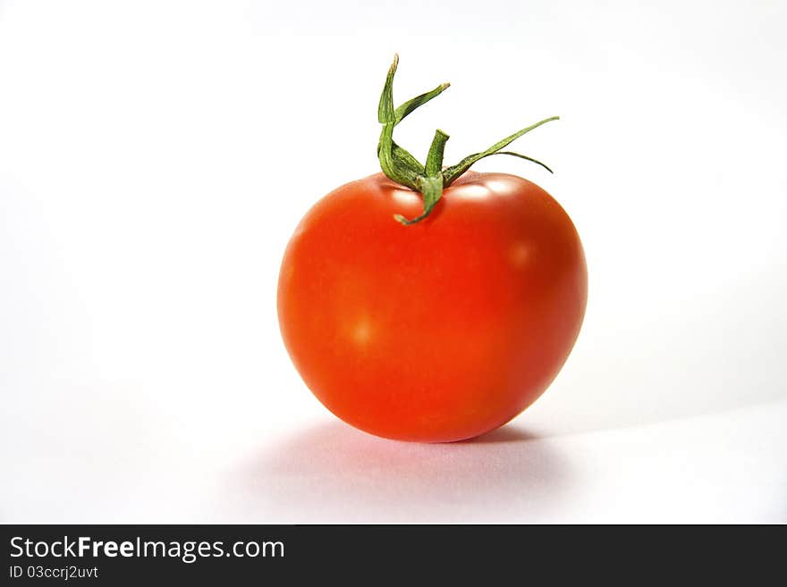 Single tomato isolated on white background. Single tomato isolated on white background.