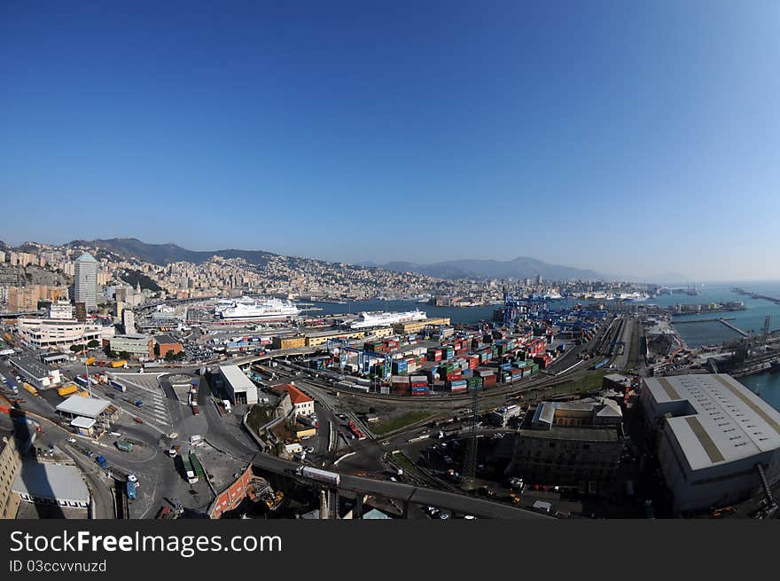 An aerial view of the port the Genoa, during a day of working, and in the background the city between sea and mountains. An aerial view of the port the Genoa, during a day of working, and in the background the city between sea and mountains.