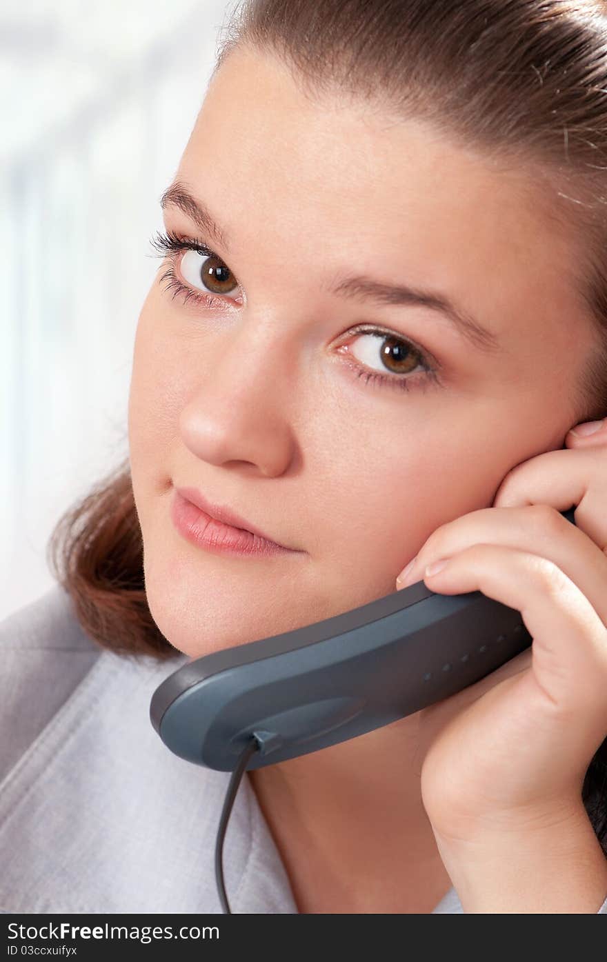 Beautiful businesswoman working with phone at her office