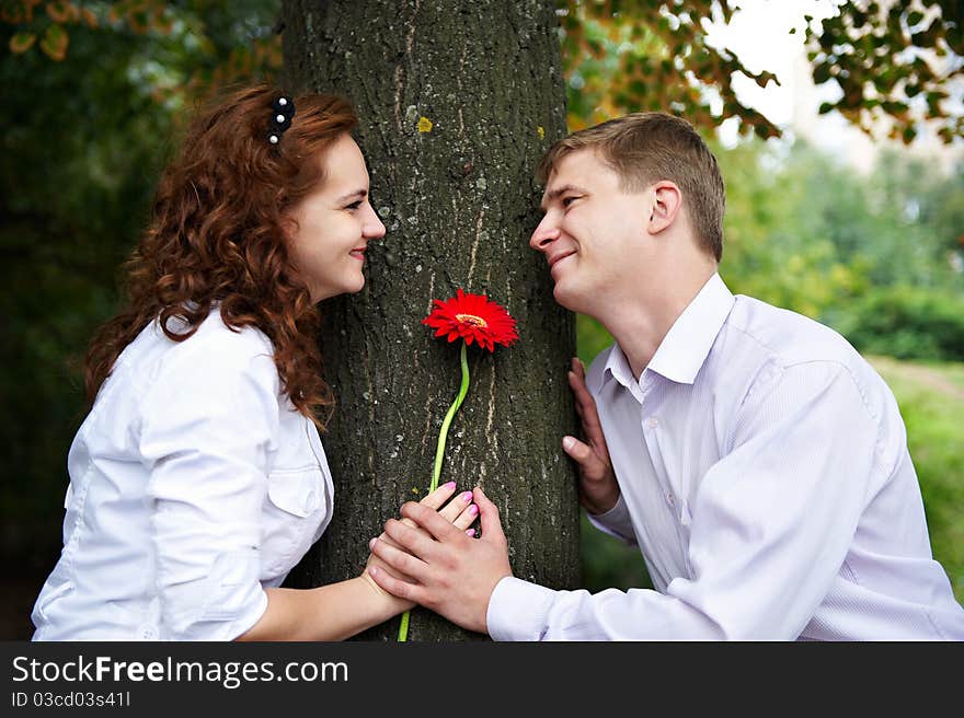 Romantic date on a date in park with red flower