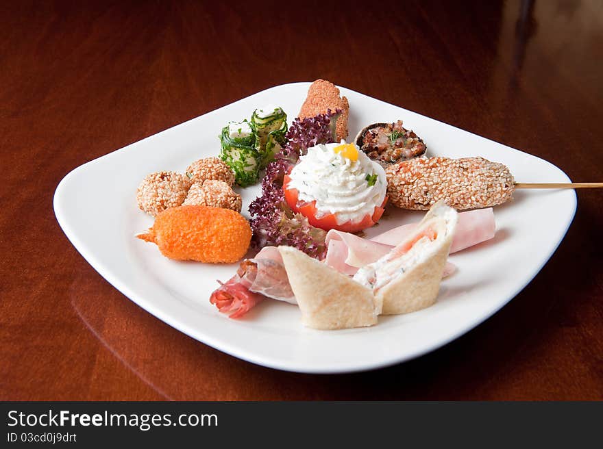 Various food items on a white plate. Various food items on a white plate