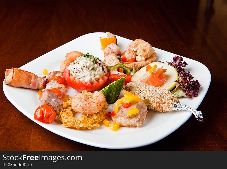 Various food items on a white plate. Various food items on a white plate