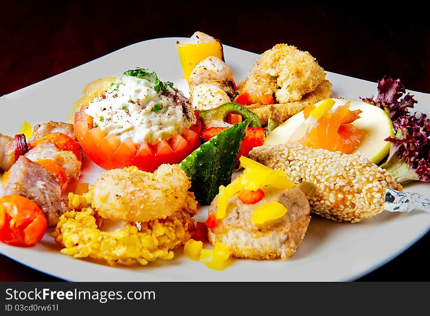 Various food items on a white plate. Various food items on a white plate