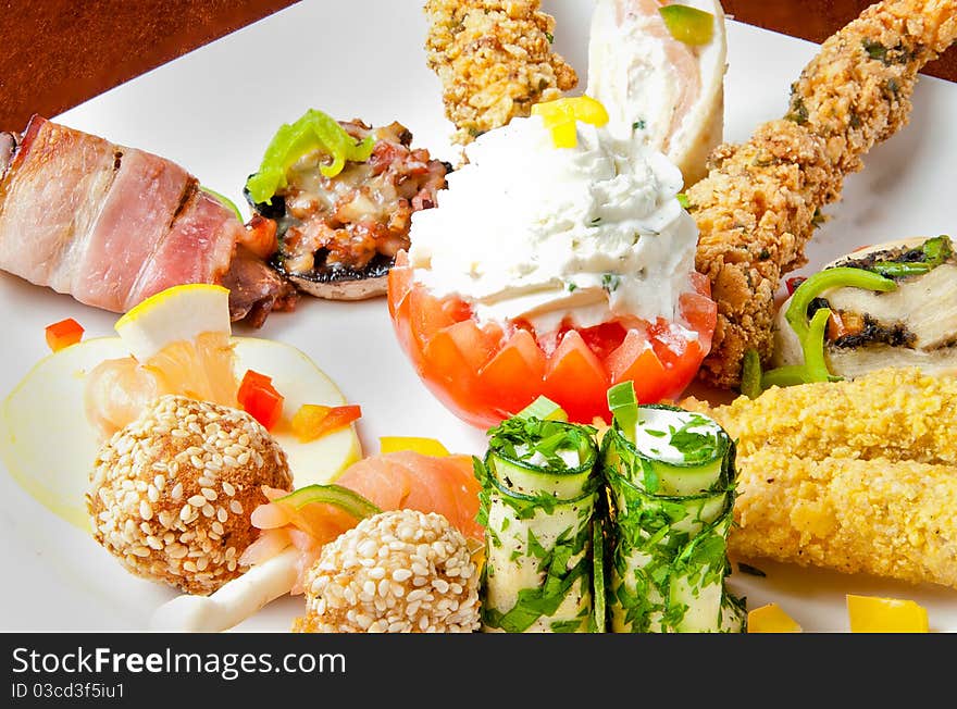 Various food items on a white plate. Various food items on a white plate