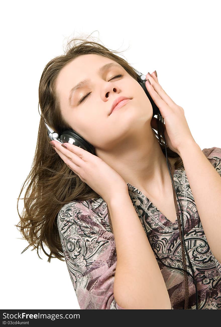 Teenage girl listening music on a white background