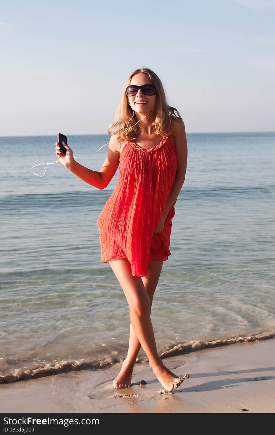 Beautiful young woman dancing on the beach. Beautiful young woman dancing on the beach