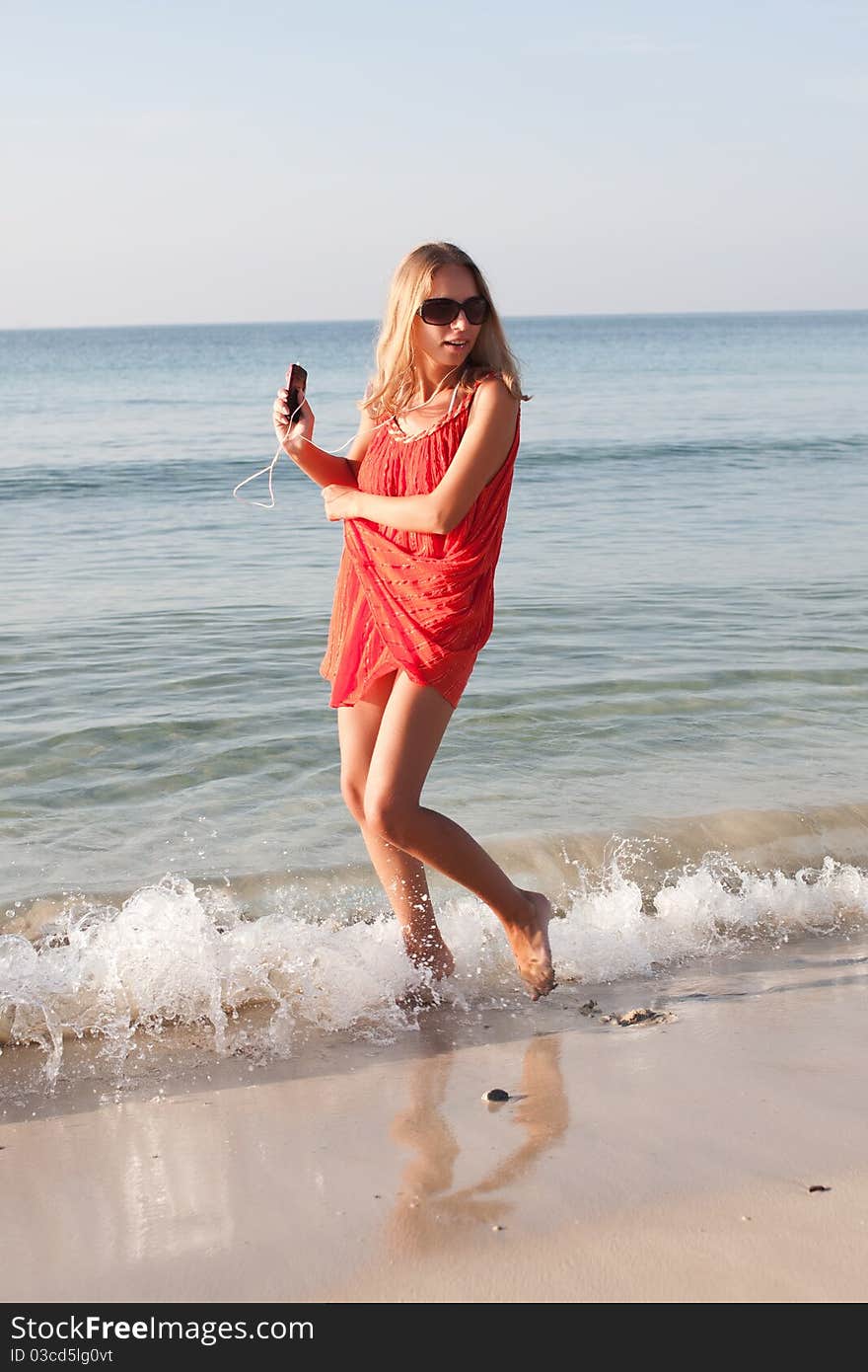 Beautiful young woman dancing on the beach. Beautiful young woman dancing on the beach