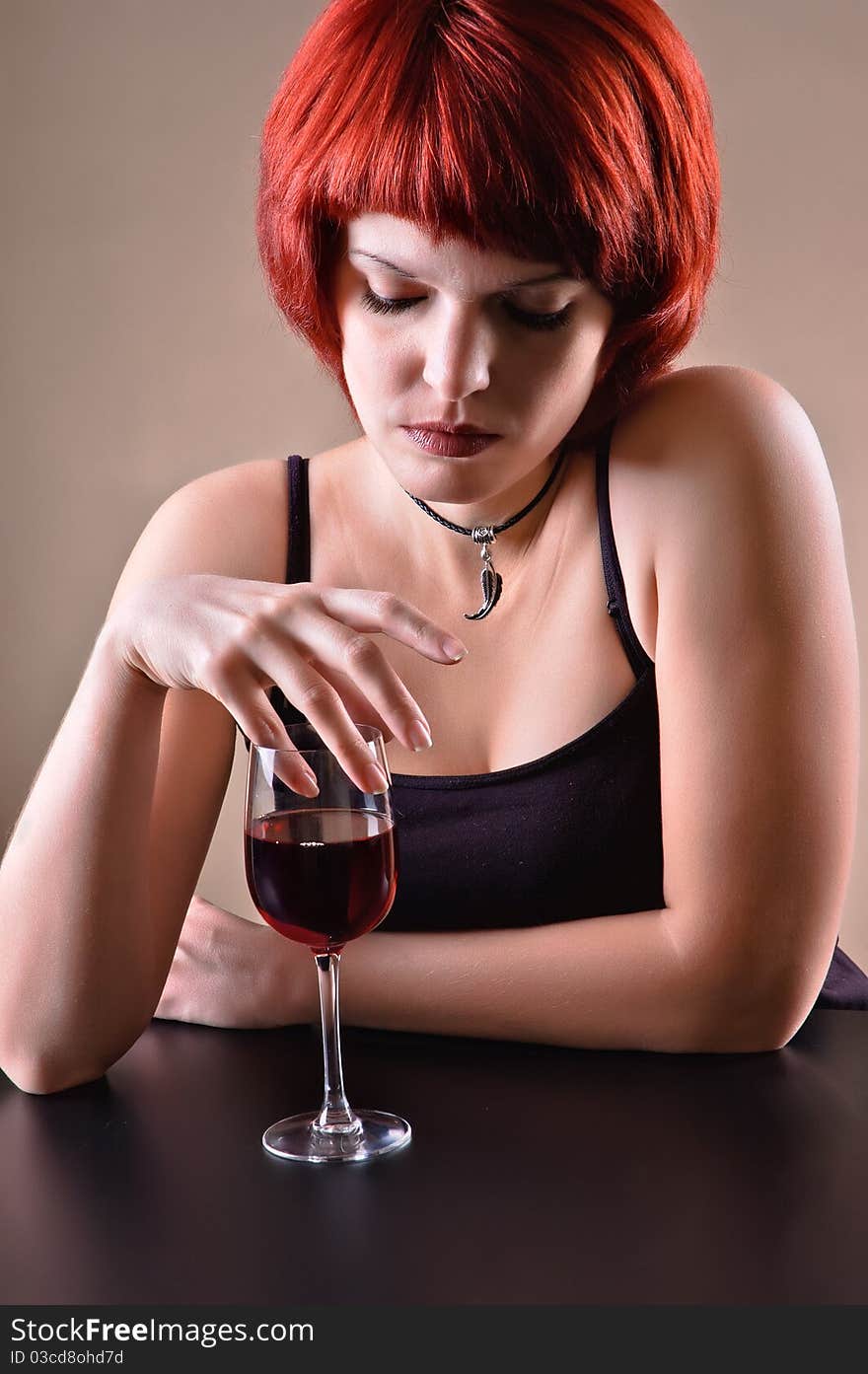 Girl c a red wine glass on a dark grey background