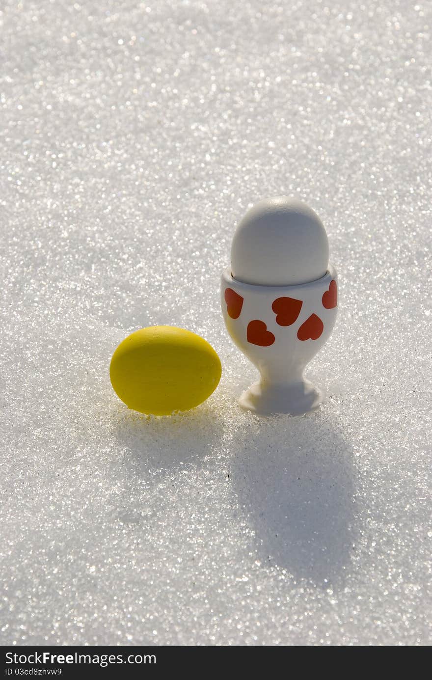 Two color Easter eggs on spring snow