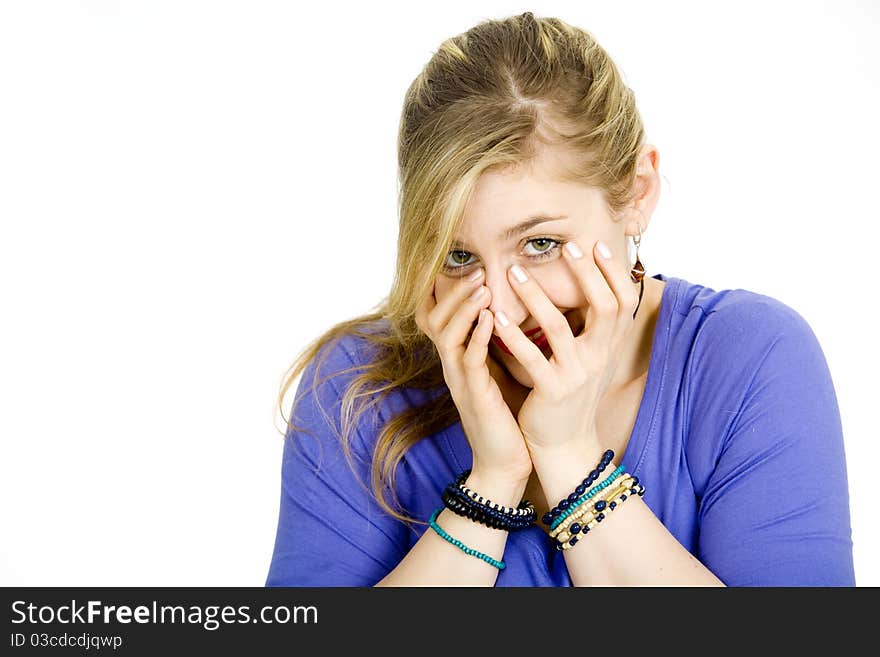 Young blond woman covering her face. Young blond woman covering her face