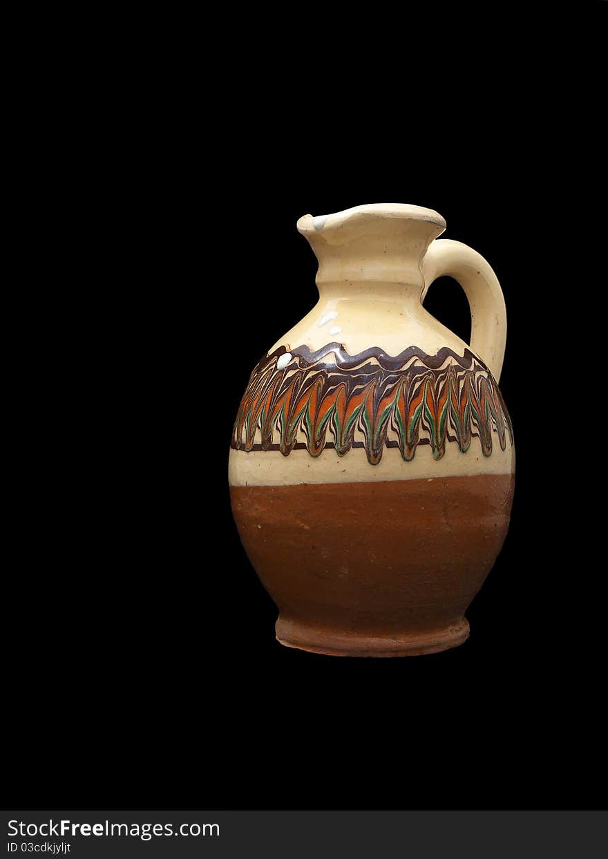 Clay pitcher with milk isolated on black background