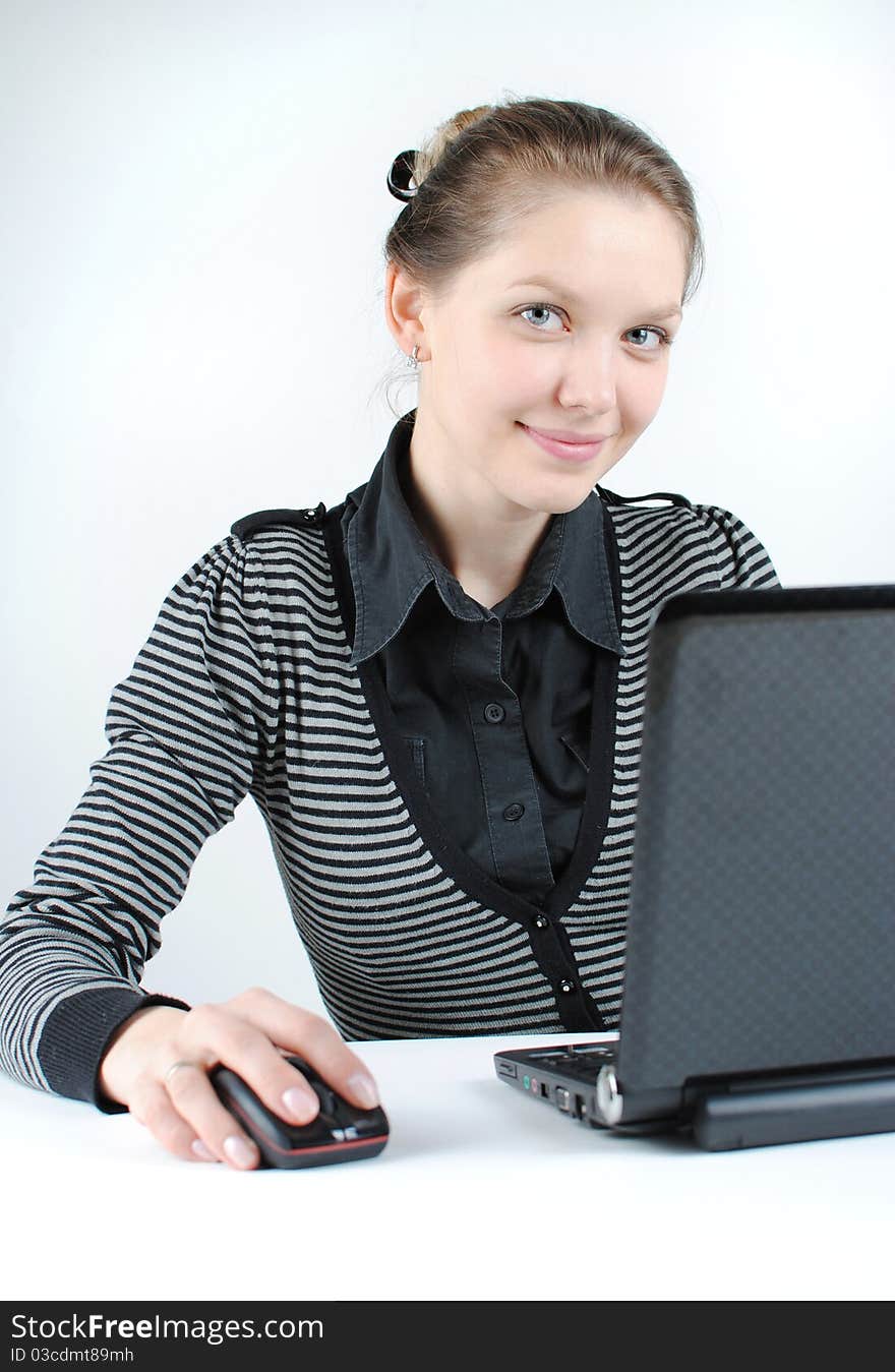 Young successful woman working at desk with laptop