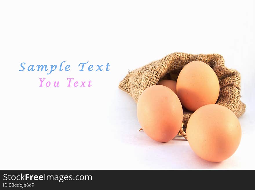 Brown eggs in canvas sack isolated on a white background