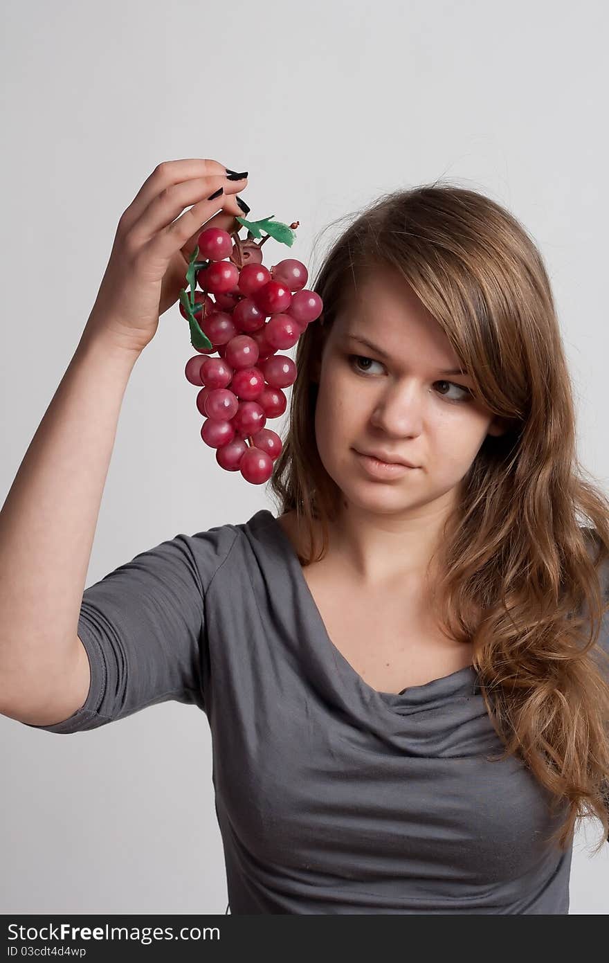 Girl with grapes in his hand